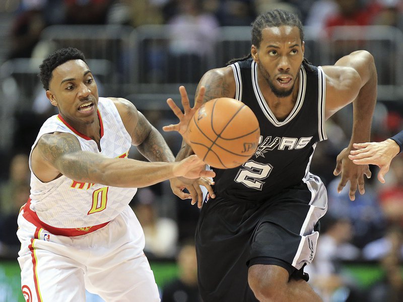 San Antonio Spurs Kawhi Leonard steals from the ball from Atlanta Hawks Jeff Teague during the first first half of an NBA preseason basketball game Wednesday, Oct. 14, 2015, in Atlanta. (Curtis Compton/Atlanta Journal-Constitution via AP) MARIETTA DAILY OUT; GWINNETT DAILY POST OUT; LOCAL TELEVISION OUT; WXIA-TV OUT; WGCL-TV OUT; MANDATORY CREDIT