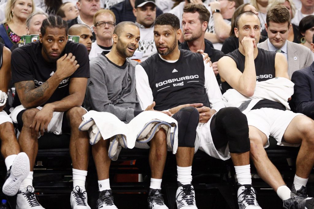 Apr 30, 2016; San Antonio, TX, USA; San Antonio Spurs players (from left to right) Kawhi Leonard, and Tony Parker, and Tim Duncan, and Manu Ginobili (20) watch on the bench against the Oklahoma City Thunder in game one of the second round of the NBA Playoffs at AT&T Center. Mandatory Credit: Soobum Im-USA TODAY Sports